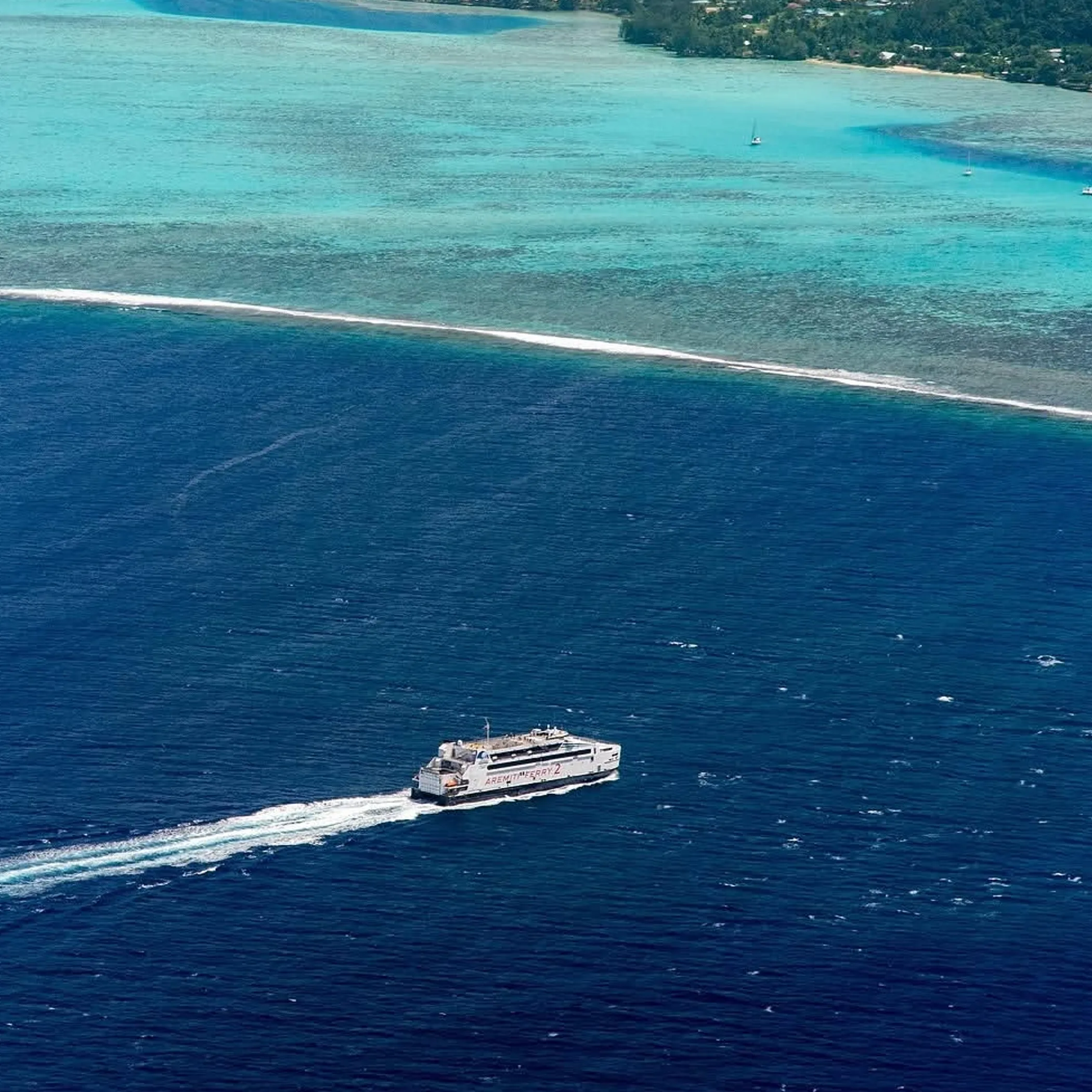boat near reef and island
